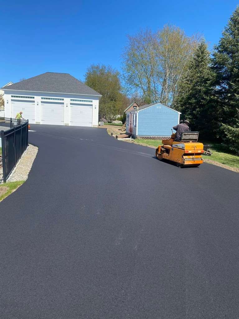 Newly paved driveway with a utility vehicle