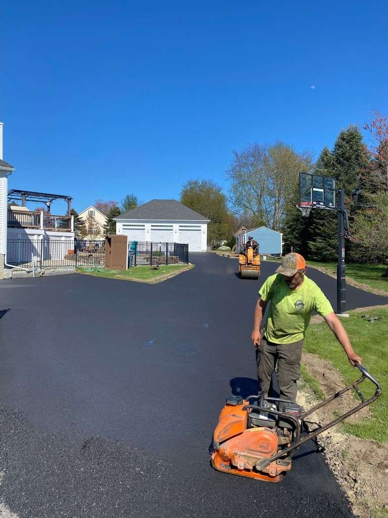 Asphalt paving crew working on driveway