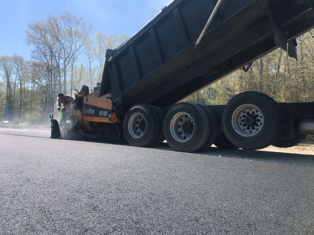 Asphalt paving machine spreading asphalt on a road